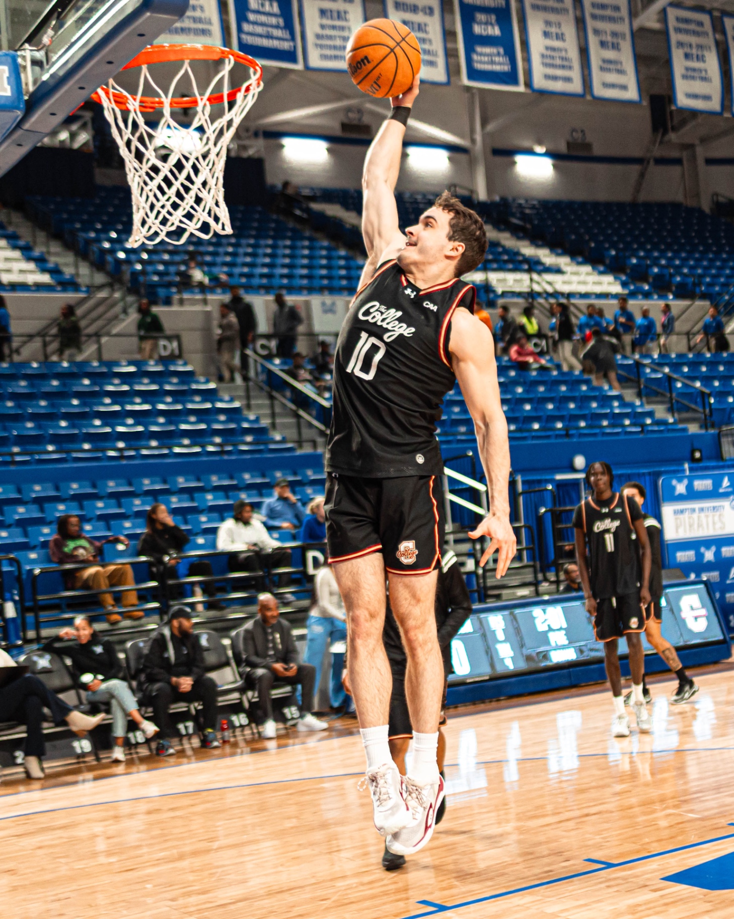 Connor Hickman finishing at the rim in a College of Charleston uniform